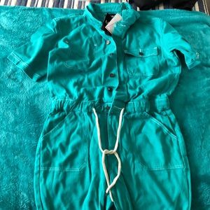 man’s green jumper, button down drawstring waist with white stitching.